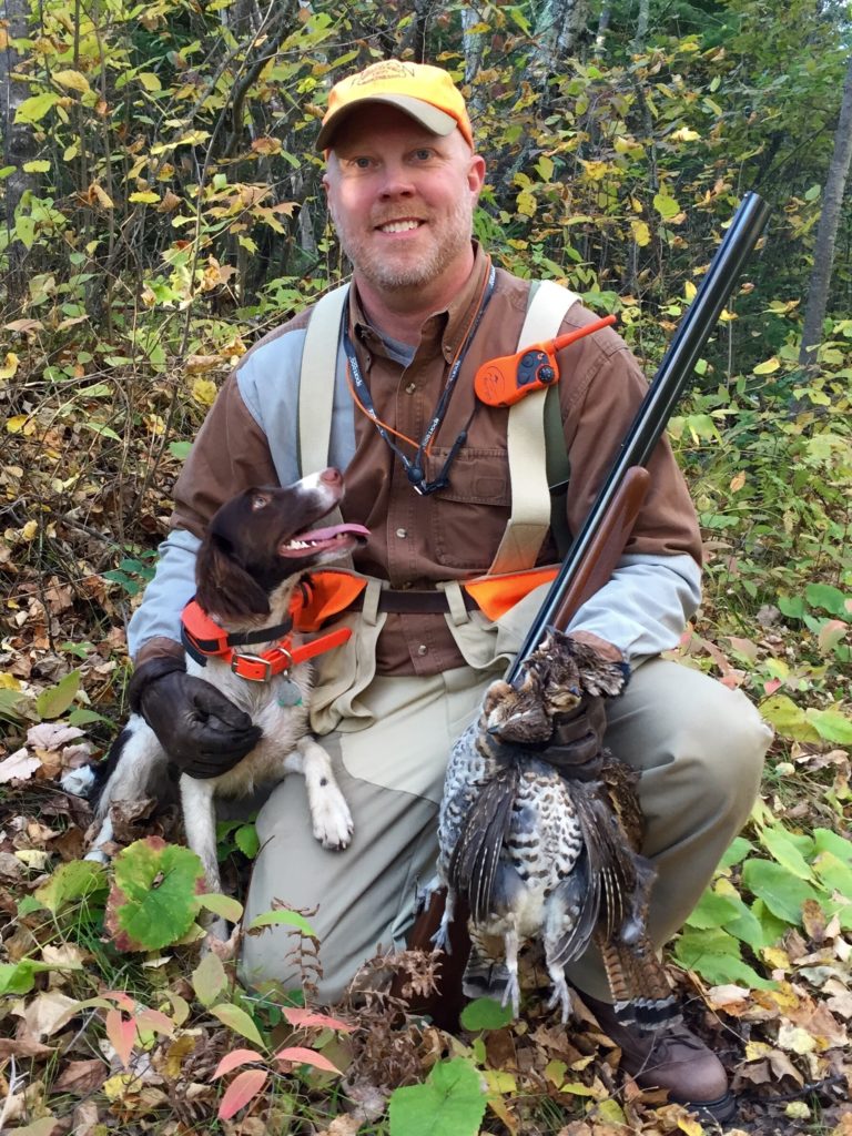 A hunter with a Brittany Spaniel and grouse. Grouse Hunting