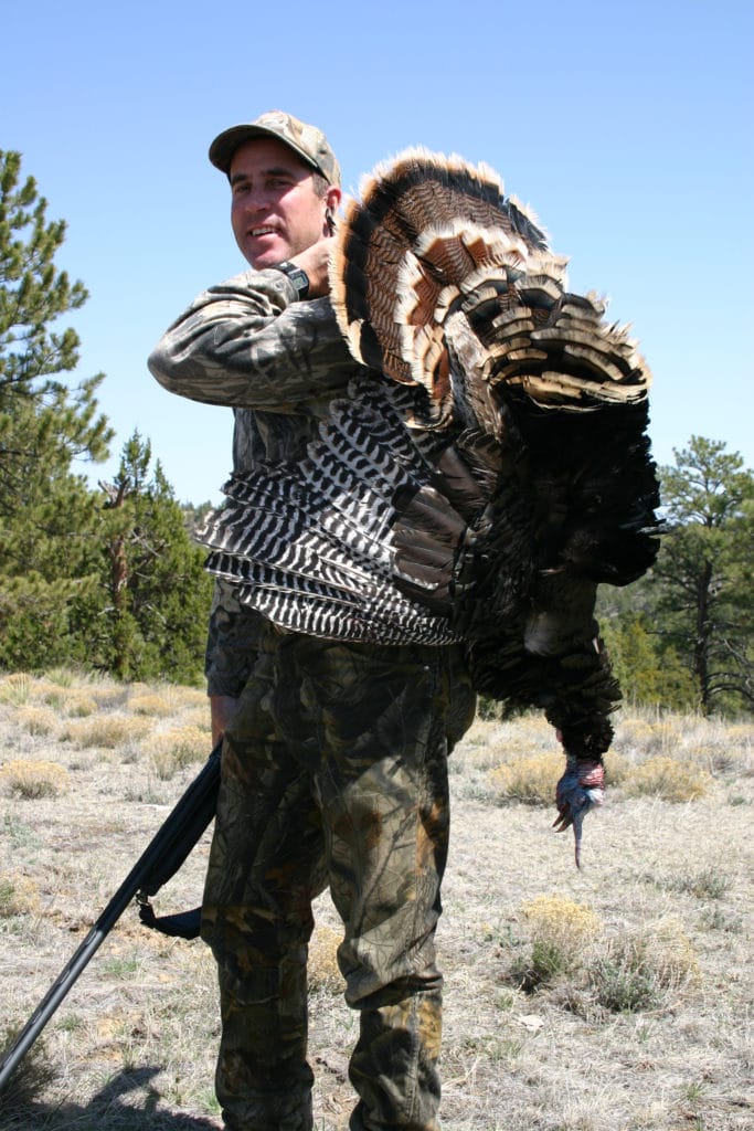 a hunter with wild turkey