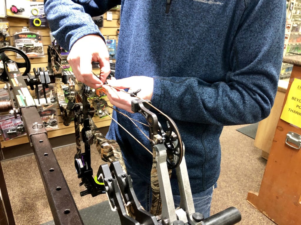 servicing a compound bow on a bow press