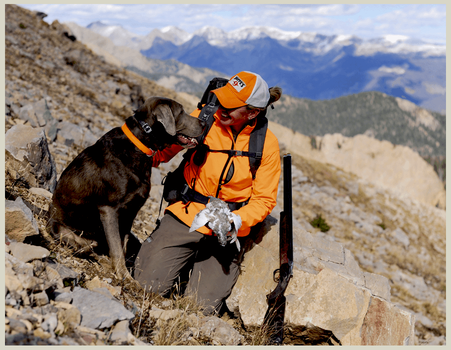 A women and dog bird hunting