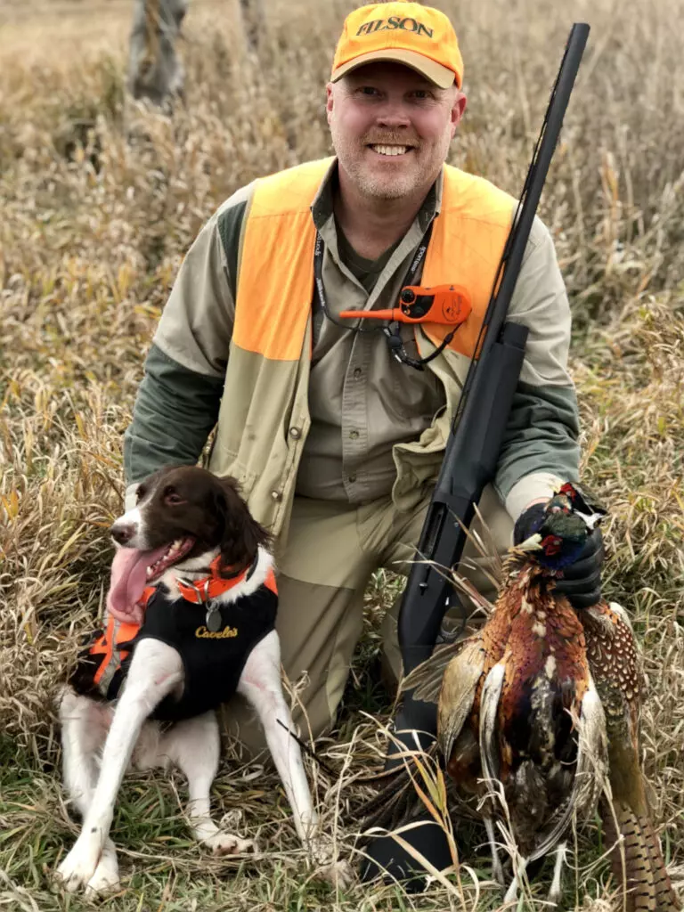 Pheasant hunter with Brittany spaniel