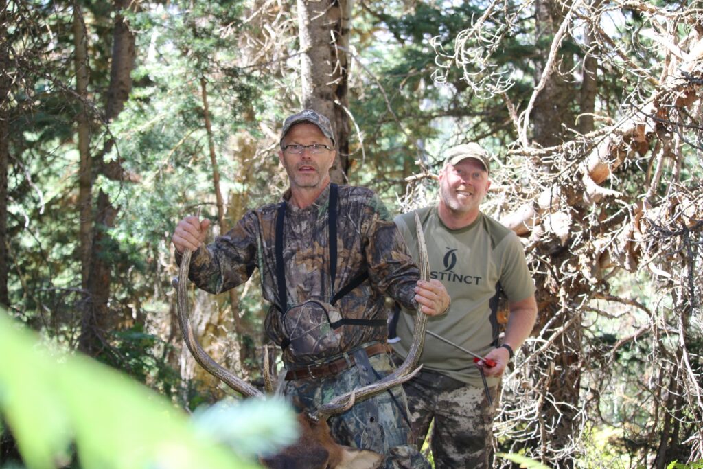 Two hunters with an elk