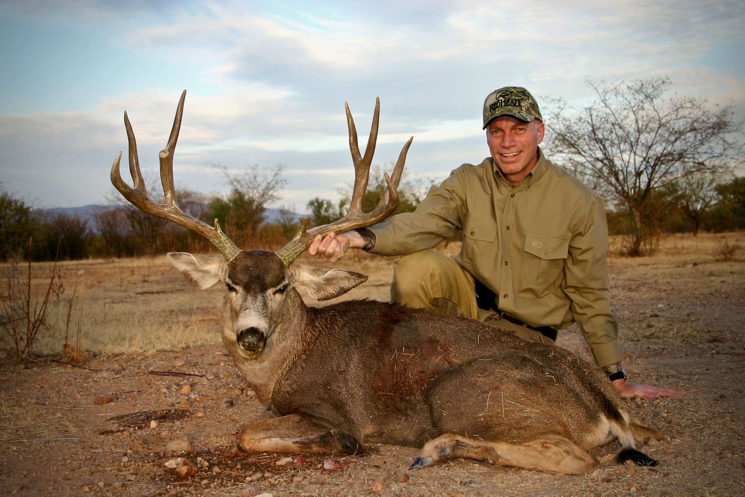 Photo of a hunter with a trophy mule deer