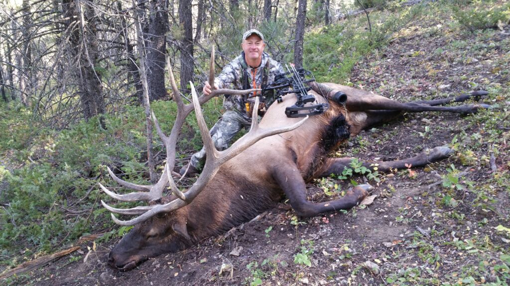 Mark Kayser with a Montana bull shot on a public-land, DIY, solo hunt in the backcountry, copyright Mark Kayser