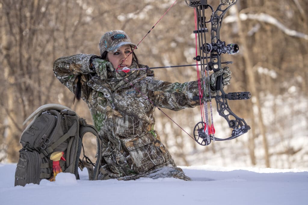 Woman hunter shooting a bow
