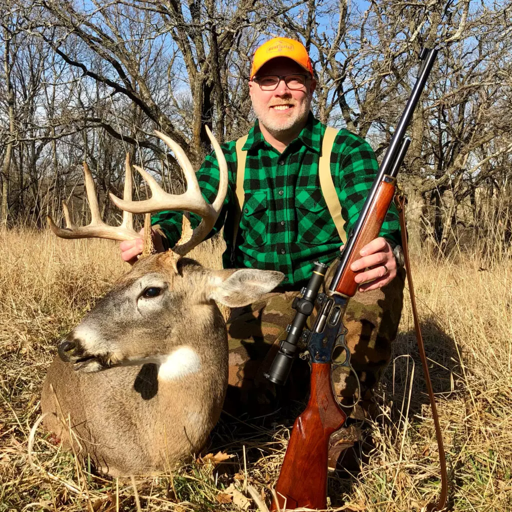 hunter with whitetail buck