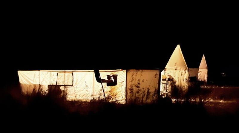 Hunting camp wall tents at night