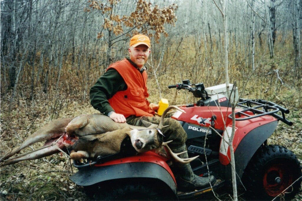 Hunter and deer on a ATV