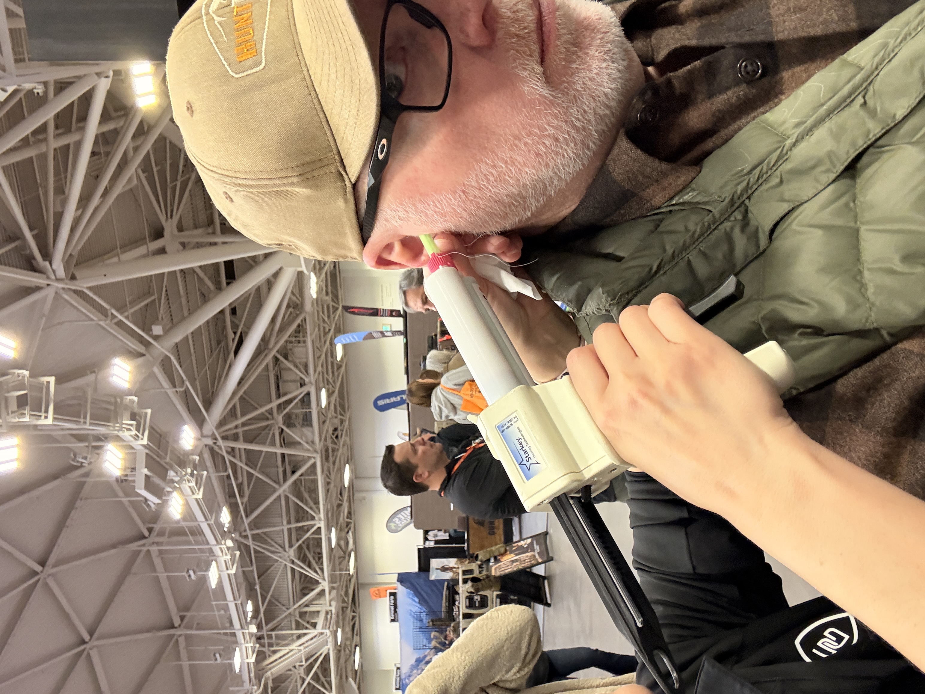 Filling my ear canal with "goop" to make a mold of the inner ear. 